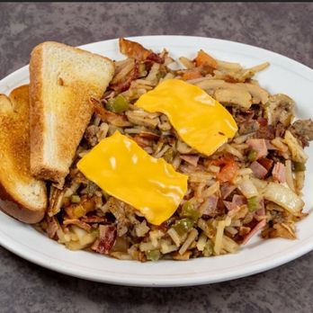 Breakfast hash topped with cheese, with toast
